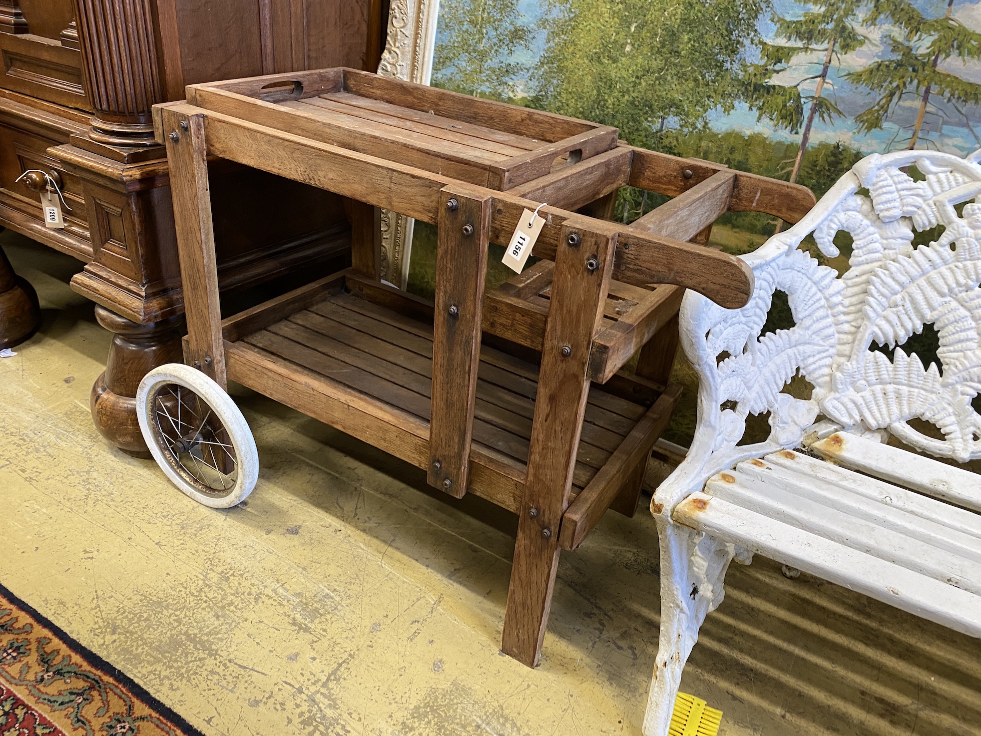 A stained teak tray top garden tea trolley, width 98cm, depth 46cm, height 74cm